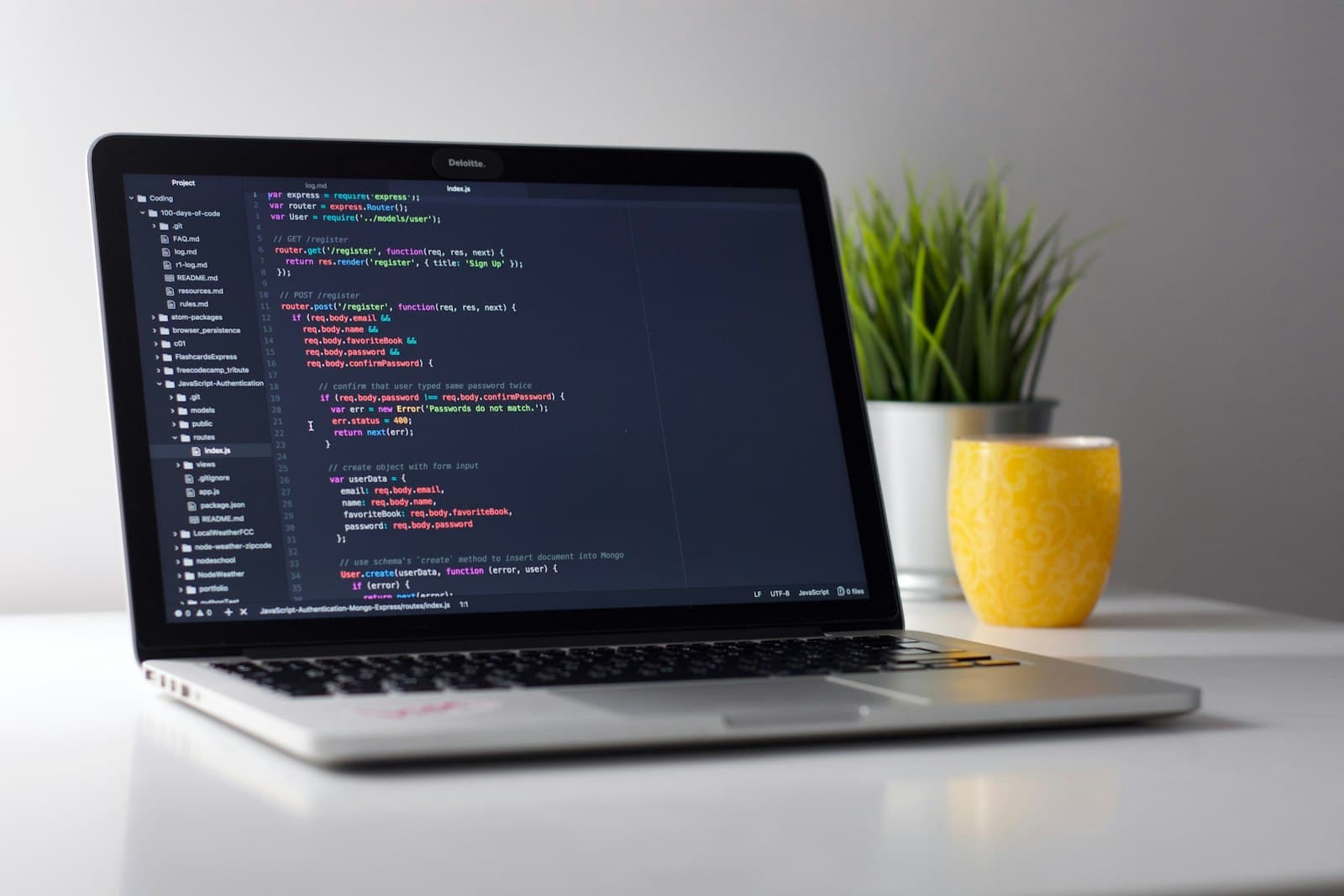 Laptop showing back-end code in an editor
